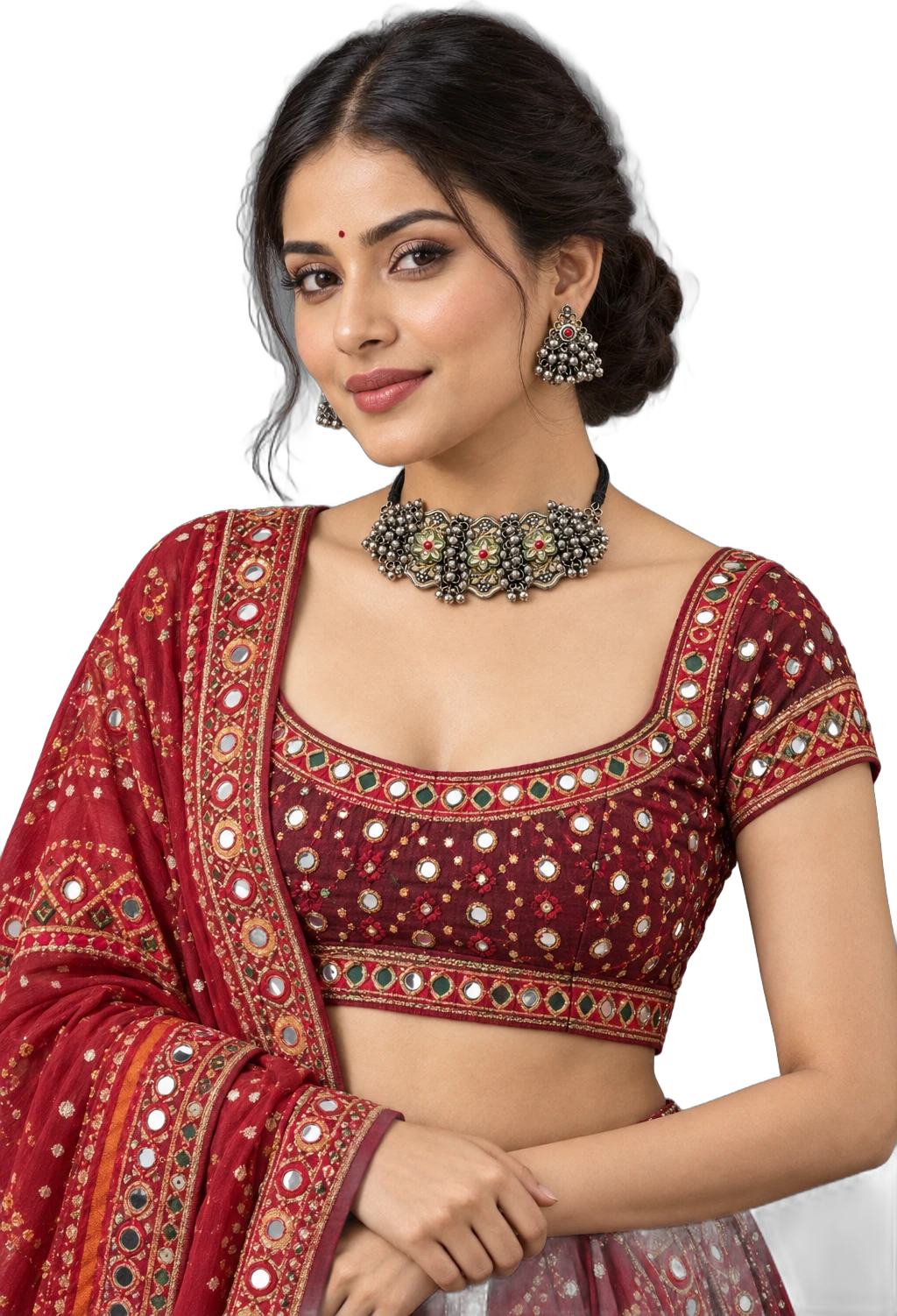 A model in a red mirror-work chaniya choli wearing an oxidised silver choker and jhumkas